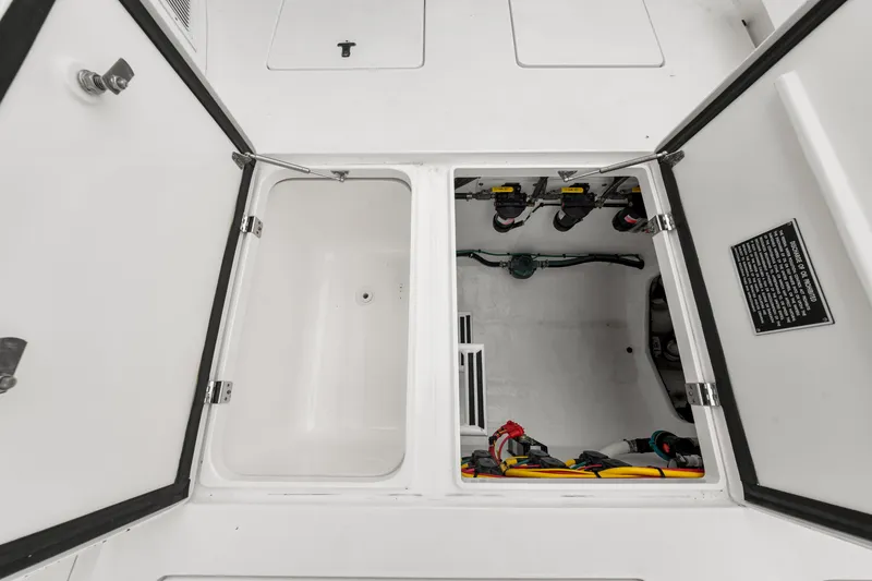 Slide: The Image of 2019 Intrepid 410 Evolution storage compartments with electrical components and wiring. - 33