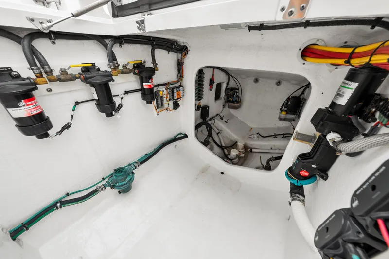 Slide: The Image of Engine room of 2019 Intrepid 410 Evolution boat, showcasing fuel filters and wiring. - 34