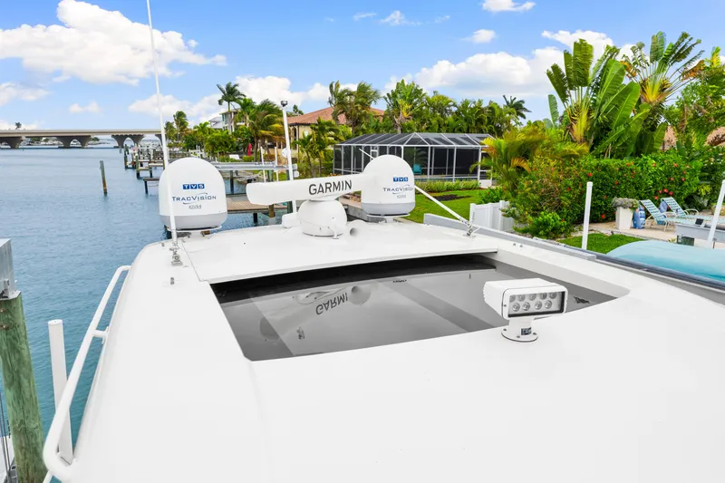Slide: The Image of 2019 Intrepid 410 Evolution yacht with Garmin and TracVision equipment, docked by waterfront homes. - 42
