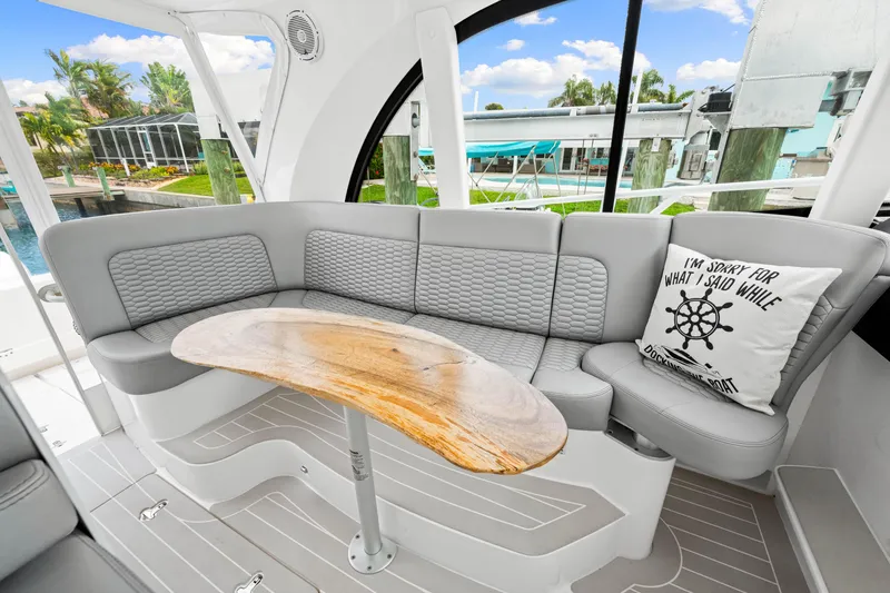 Slide: The Image of Luxurious 2019 Intrepid 410 Evolution yacht interior with elegant seating and wooden table. - 45