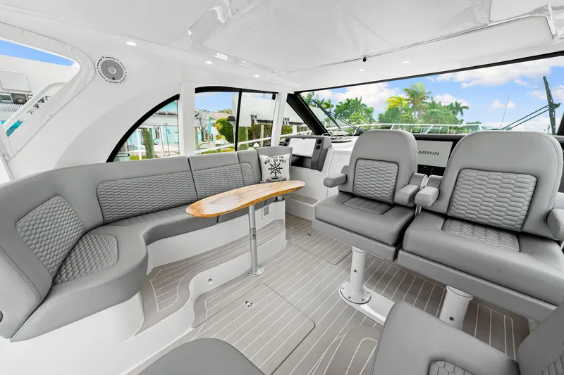 Slide: The Image of Luxurious interior of 2019 Intrepid 410 Evolution yacht with gray seating and wooden table. - 54