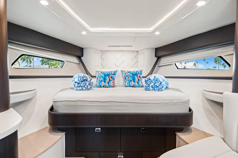 Slide: The Image of Luxurious cabin interior of 2019 Intrepid 410 Evolution yacht with elegant bedding and decor. - 63