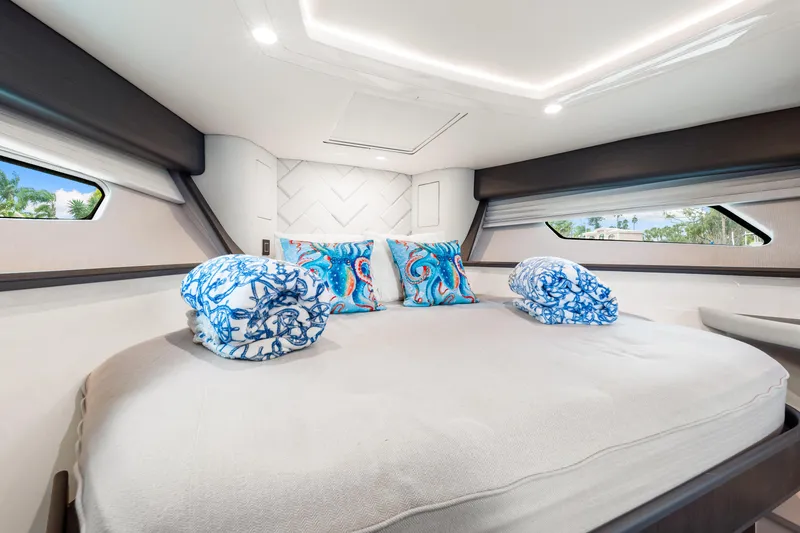 Slide: The Image of Luxurious cabin interior of 2019 Intrepid 410 Evolution yacht with elegant bedding. - 64