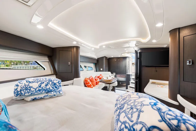 Slide: The Image of Luxurious interior of 2019 Intrepid 410 Evolution yacht with elegant bedding and modern amenities. - 65