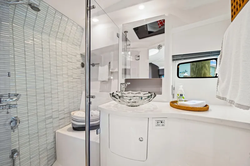 Slide: The Image of Luxurious bathroom in 2019 Intrepid 410 Evolution yacht with modern glass sink and shower. - 67