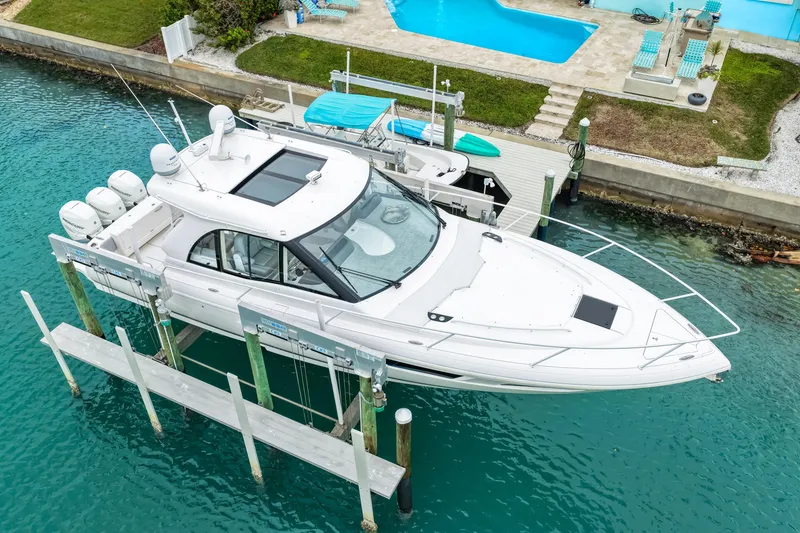 Slide: The Image of 2019 Intrepid 410 Evolution yacht docked, featuring sleek design and multiple engines. - 7