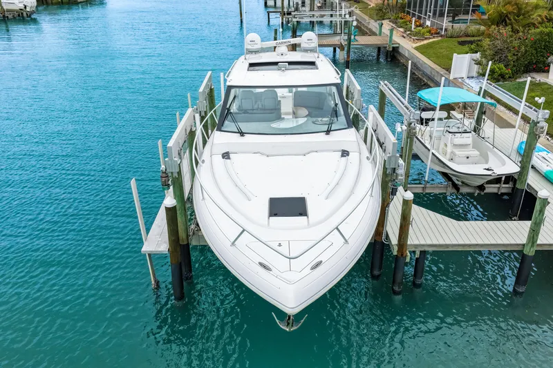 Slide: The Image of 2019 Intrepid 410 Evolution yacht docked in clear blue water. - 8