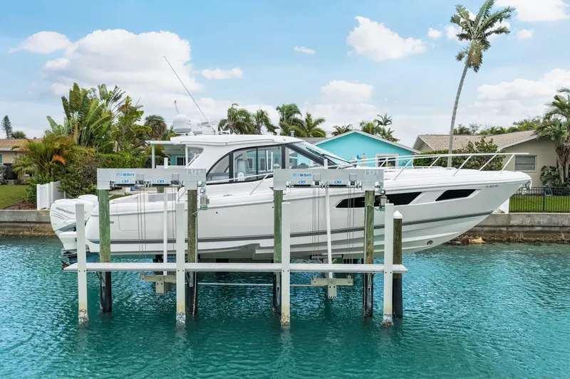 Slide: The Image of 2019 Intrepid 410 Evolution yacht on lift, surrounded by tropical scenery. - 9