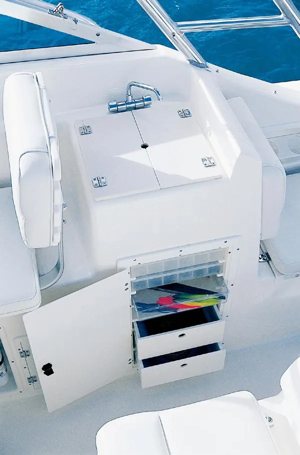 Slide: The Image of 2003 Pursuit 2865 Denali boat interior with cushioned seating and sleek design. - 11