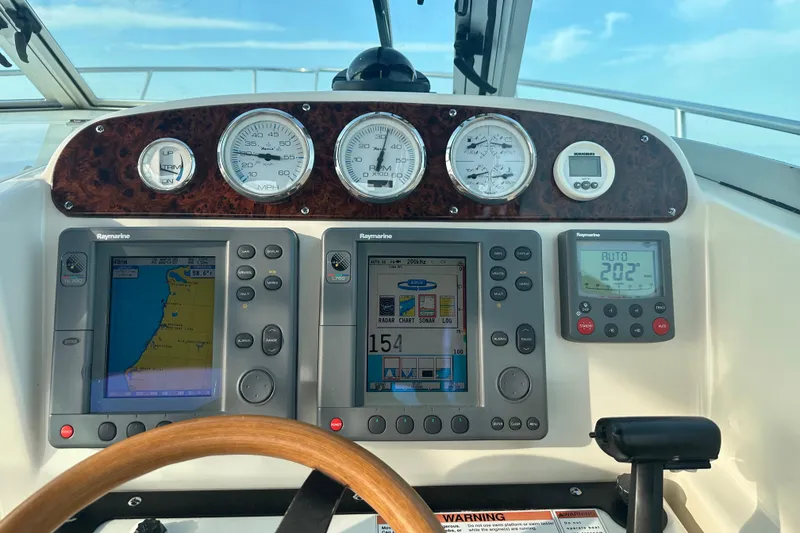 Slide: The Image of 2003 Pursuit 2865 Denali boat interior in storage, featuring seating and equipment. - 4