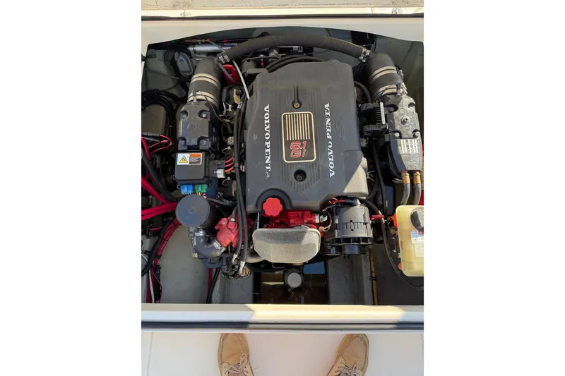 Slide: The Image of 2003 Pursuit 2865 Denali boat interior with white seating and red buoys. - 5