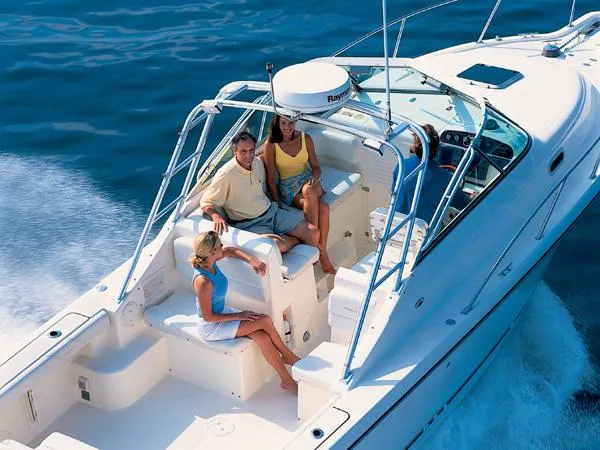 Slide: The Image of 2003 Pursuit 2865 Denali boat interior with white seating and ambient lighting. - 8