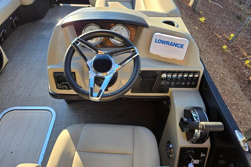 Slide: The Image of 2020 Barletta C22UC boat dashboard with steering wheel and Lowrance device. - 10