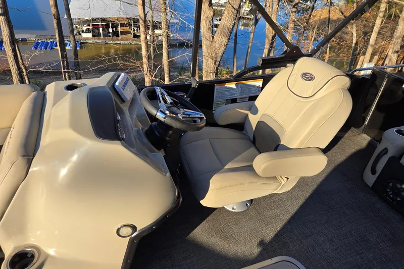 Slide: The Image of 2020 Barletta C22UC boat interior with beige captain's chair and steering wheel. - 11