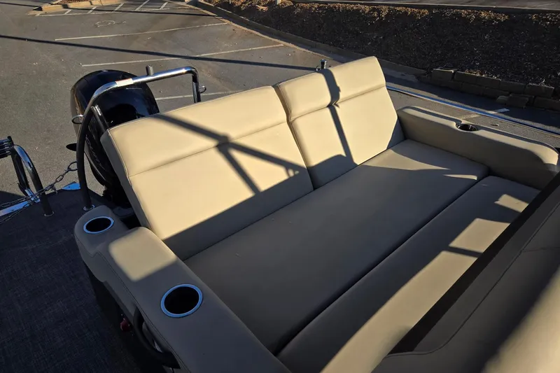 Slide: The Image of 2020 Barletta C22UC boat with beige seating and cup holders in a parking lot. - 14