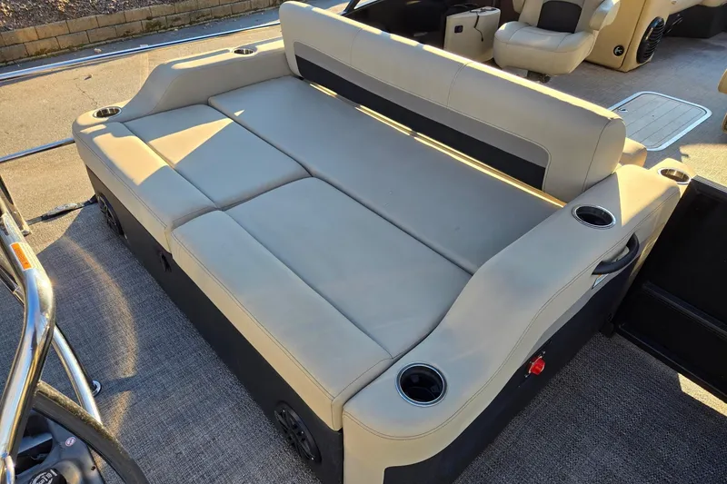Slide: The Image of 2020 Barletta C22UC boat interior with beige seating and cup holders. - 15