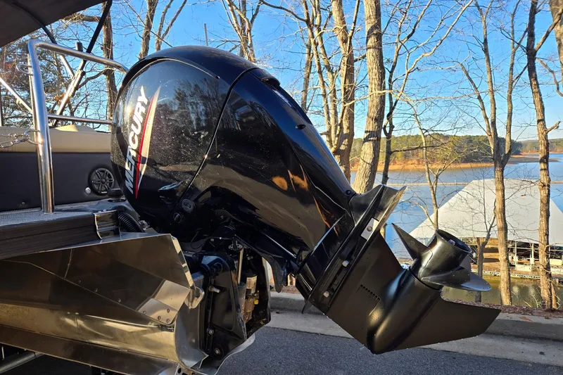 Slide: The Image of 2020 Barletta C22UC boat with Mercury outboard motor by a lake. - 19