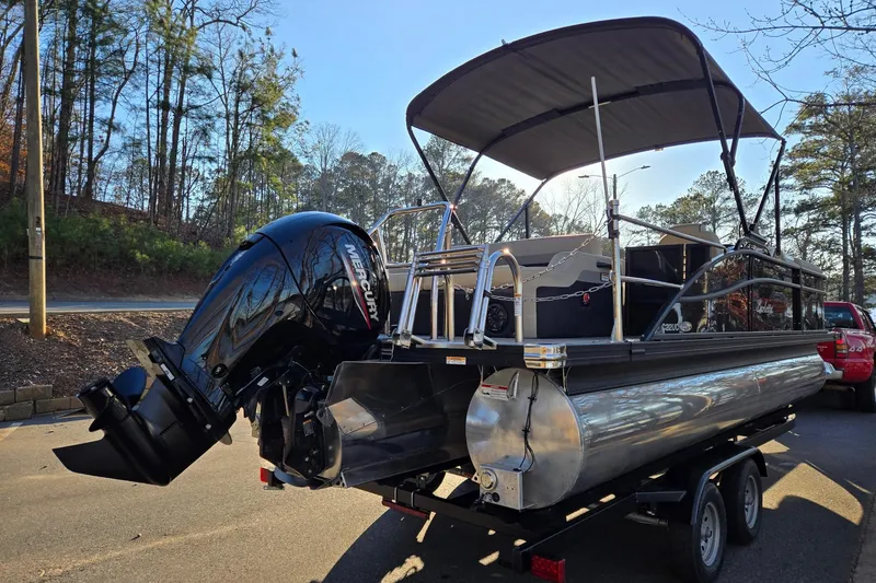 Slide: The Image of 2020 Barletta C22UC pontoon boat with Mercury outboard motor on trailer. - 5