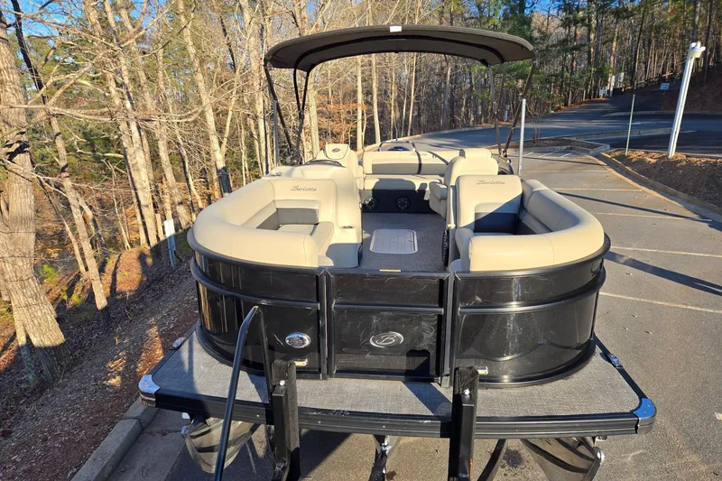 Slide: The Image of 2020 Barletta C22UC pontoon boat parked on a wooded road. - 7