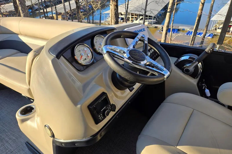 Slide: The Image of 2020 Barletta C22UC boat interior with steering wheel and dashboard controls. - 9