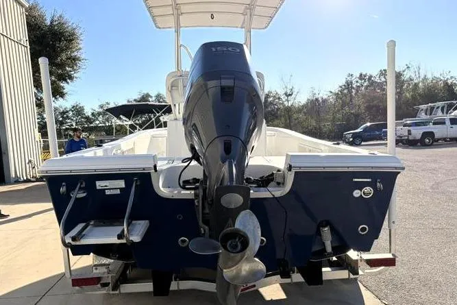 Slide: The Image of 2011 Sea Hunt BX 22 BR boat with outboard motor, parked outdoors. - 10