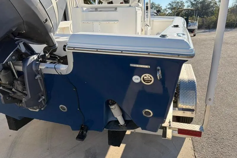 Slide: The Image of 2011 Sea Hunt BX 22 BR boat rear view with motor and trailer. - 12