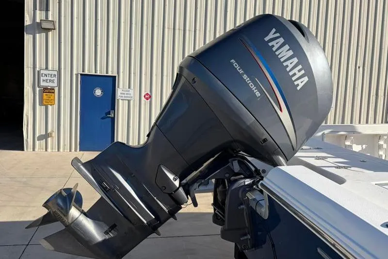 Slide: The Image of 2011 Sea Hunt BX 22 BR with Yamaha four-stroke outboard motor in a marina setting. - 13