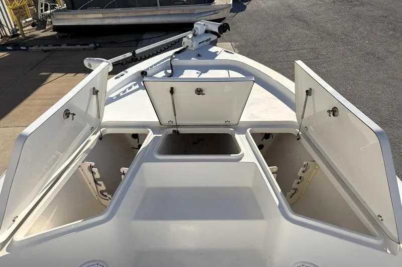 Slide: The Image of 2011 Sea Hunt BX 22 BR boat with open storage compartments on deck. - 20