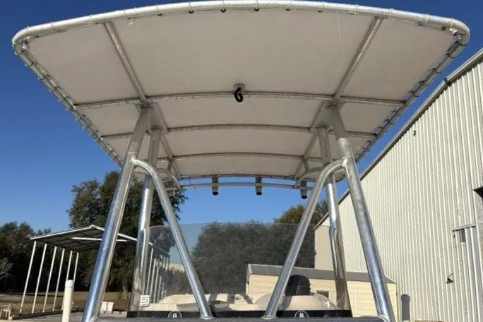 Slide: The Image of 2011 Sea Hunt BX 22 BR boat with T-top canopy, outdoor setting. - 22