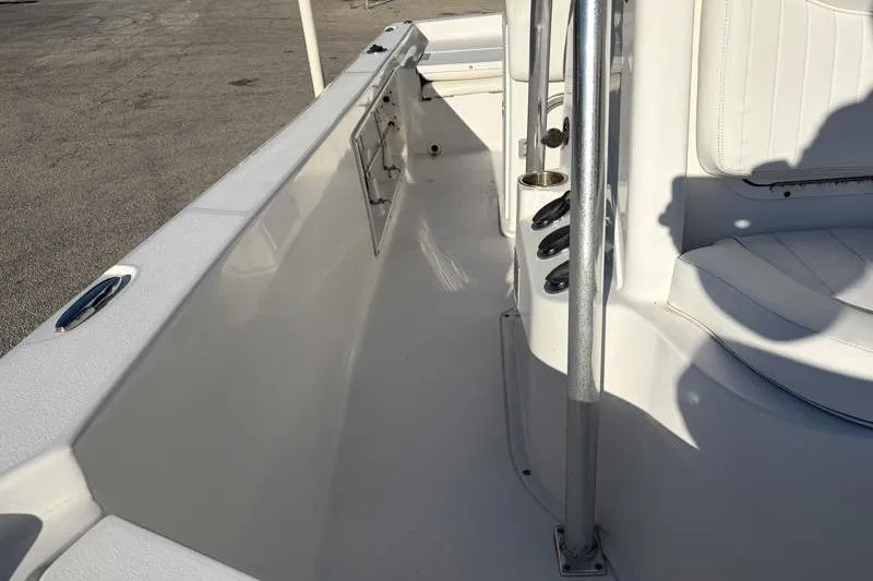 Slide: The Image of 2011 Sea Hunt BX 22 BR boat interior with white seating and rod holders. - 23