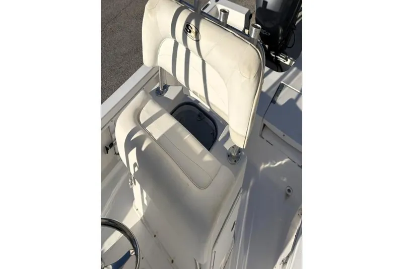 Slide: The Image of 2011 Sea Hunt BX 22 BR boat interior with white seating and steering wheel. - 25