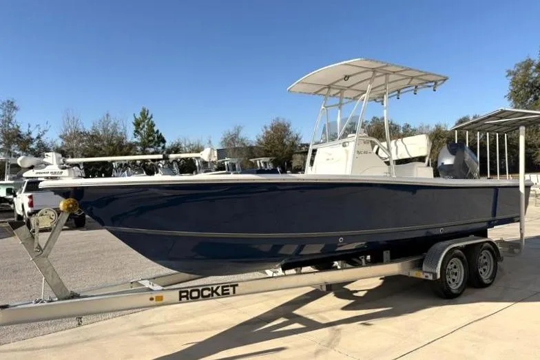 Slide: The Image of 2011 Sea Hunt BX 22 BR boat on trailer, parked outdoors under clear sky. - 3