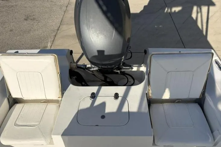 Slide: The Image of 2011 Sea Hunt BX 22 BR boat with dual seats and motor, docked on concrete. - 32