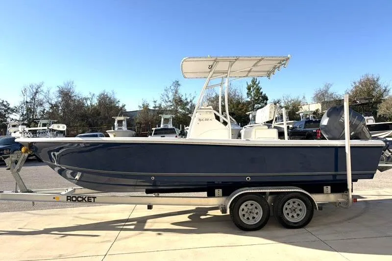 Slide: The Image of 2011 Sea Hunt BX 22 BR boat on trailer, parked outdoors under clear sky. - 4