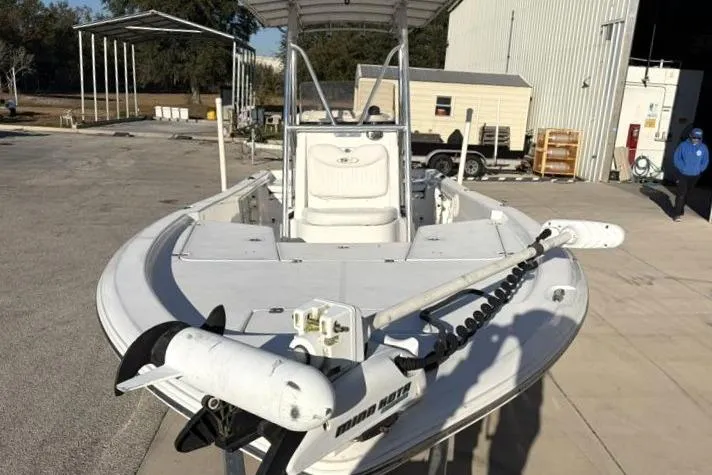 Slide: The Image of 2011 Sea Hunt BX 22 BR boat with trolling motor in a marina setting. - 6