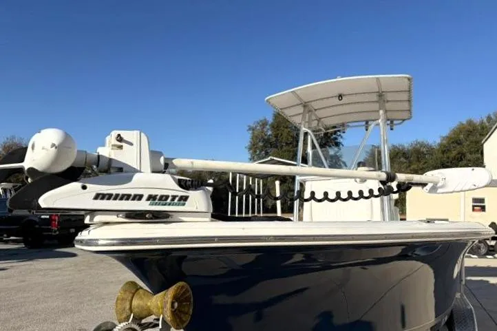 Slide: The Image of 2011 Sea Hunt BX 22 BR boat with Minn Kota trolling motor, blue hull, and T-top canopy. - 7