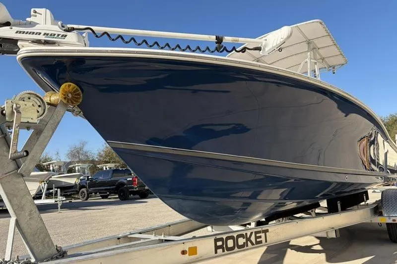 Slide: The Image of 2011 Sea Hunt BX 22 BR boat on trailer, blue hull, sunny day. - 9