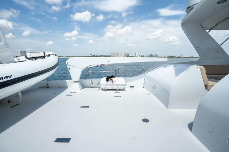 Slide: The Image of Spacious deck of 2000 Hatteras 75 Sport Deck Motor Yacht under clear skies. - 34