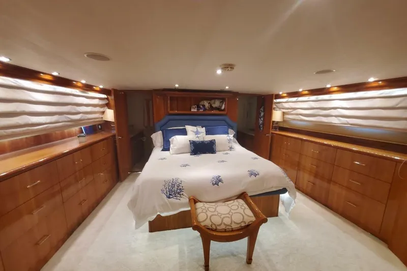 Slide: The Image of Luxurious bedroom interior of 2000 Hatteras 75 Sport Deck Motor Yacht with elegant wood finishes. - 10