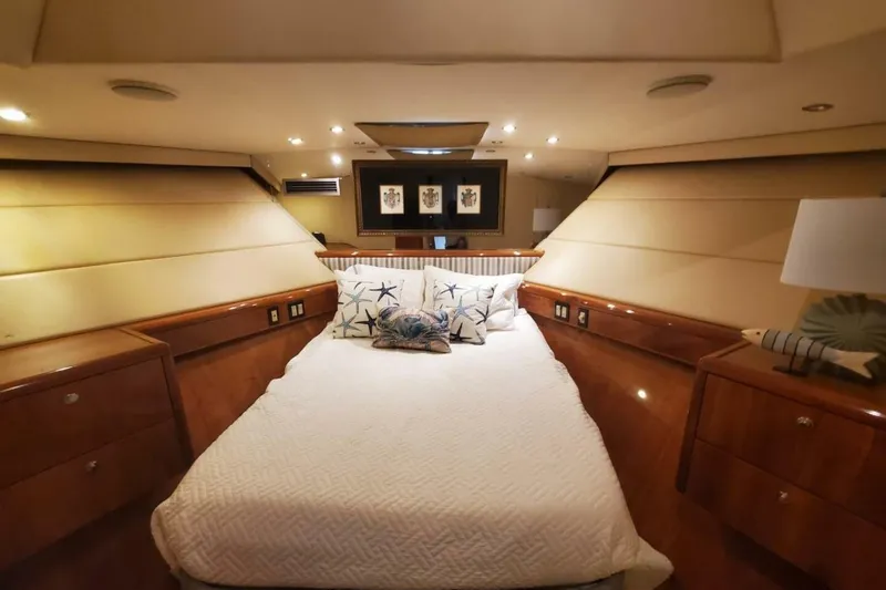 Slide: The Image of Luxurious bedroom interior of 2000 Hatteras 75 Sport Deck Motor Yacht with elegant wood finish. - 11