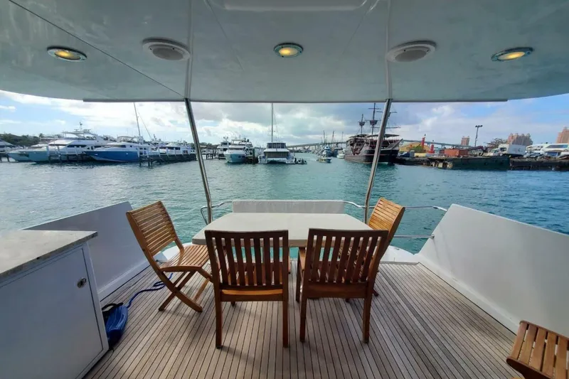 Slide: The Image of Aft deck of 2000 Hatteras 75 Sport Deck Motor Yacht with marina view. - 15