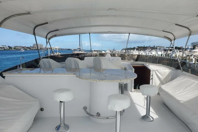Slide: The Image of Luxurious 2000 Hatteras 75 Sport Deck Motor Yacht with covered outdoor seating and ocean view. - 16