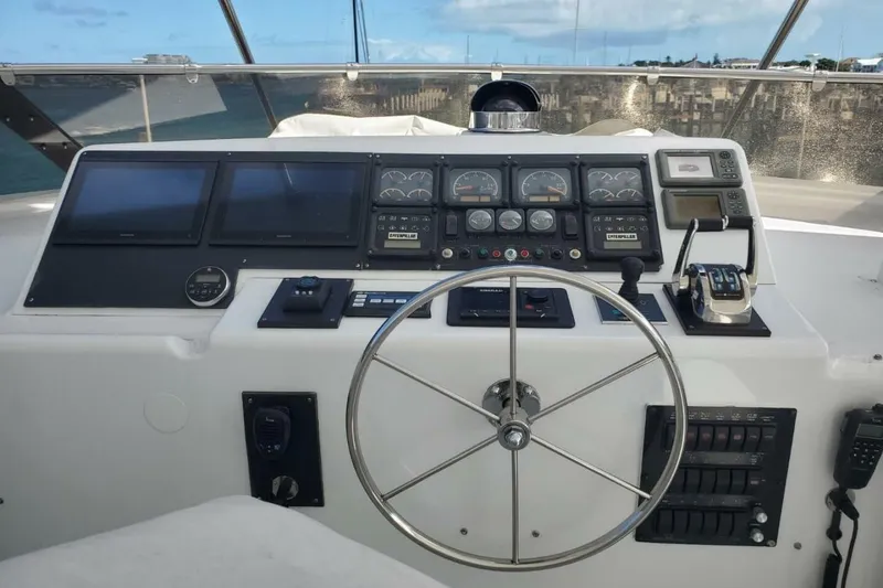 Slide: The Image of Control panel of a 2000 Hatteras 75 Sport Deck Motor Yacht with steering wheel and gauges. - 17