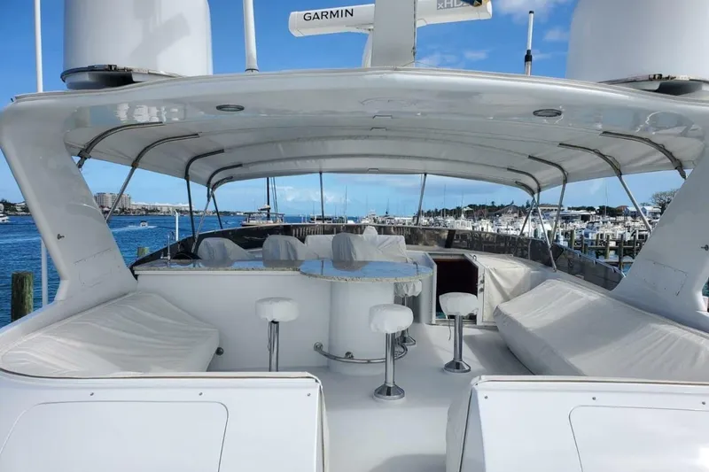 Slide: The Image of Luxurious 2000 Hatteras 75 Sport Deck Motor Yacht with spacious outdoor seating and ocean view. - 18