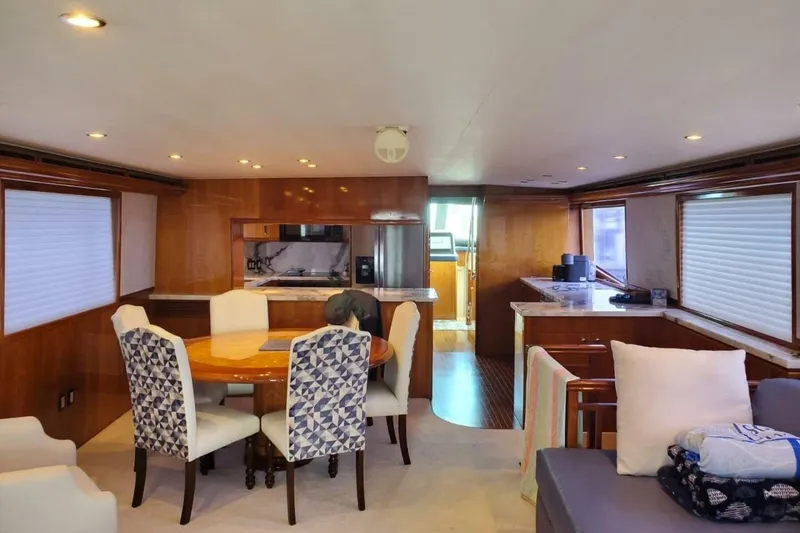 Slide: The Image of Luxurious interior of 2000 Hatteras 75 Sport Deck Motor Yacht with dining area and kitchen. - 2