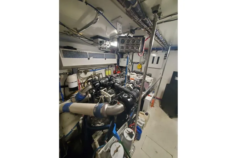 Slide: The Image of Engine room of 2000 Hatteras 75 Sport Deck Motor Yacht, showcasing machinery and equipment. - 22