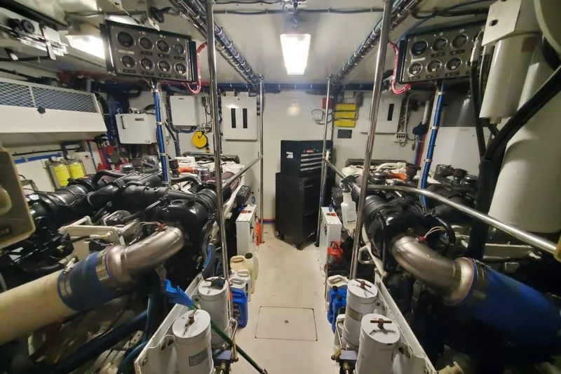 Slide: The Image of Engine room of 2000 Hatteras 75 Sport Deck Motor Yacht, showcasing machinery and equipment. - 23