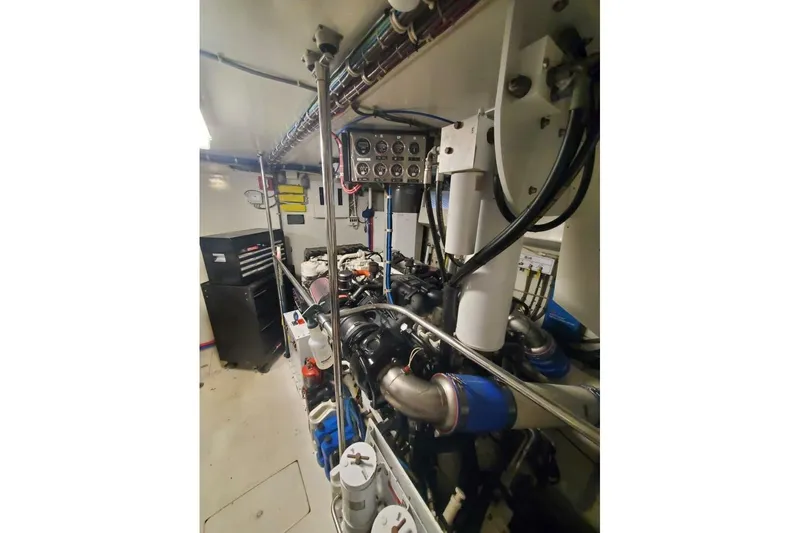 Slide: The Image of Engine room of 2000 Hatteras 75 Sport Deck Motor Yacht, showcasing machinery and control panels. - 24