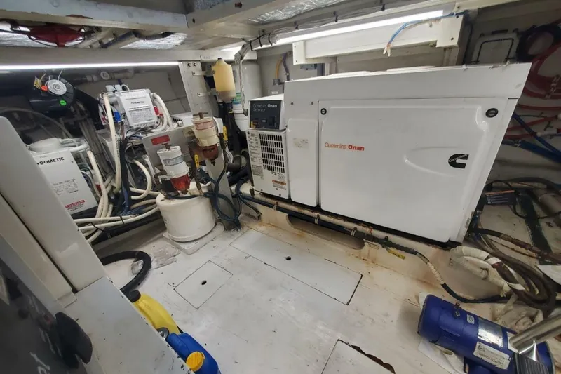 Slide: The Image of Engine room of 2000 Hatteras 75 Sport Deck Motor Yacht with Cummins Onan generator. - 25