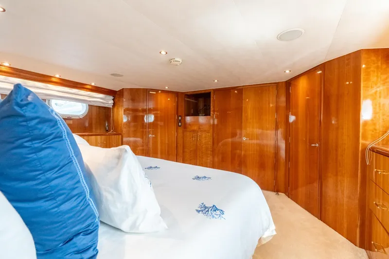 Slide: The Image of Luxurious bedroom interior of 2000 Hatteras 75 Sport Deck Motor Yacht with wood paneling. - 52